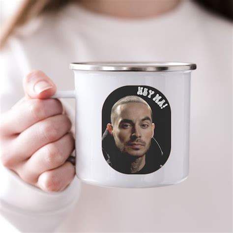 a woman holding a white coffee mug with a photo of her face on the front