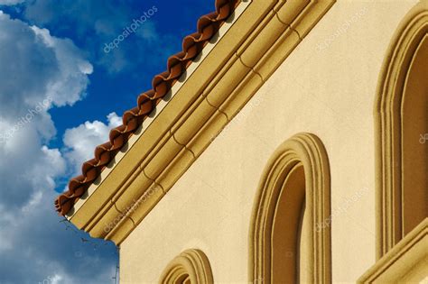 Stucco Wall Arched Windows and Clouds Stock Photo by ©Feverpitch 2360545