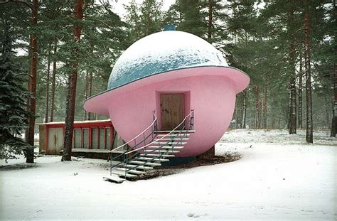 a pink building with stairs leading up to it in the middle of snow ...