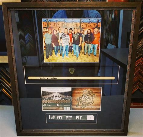 @zacbrownband photo, guitar pick, drumstick, album and wristband framed in @larsonjuhl's Ansley ...