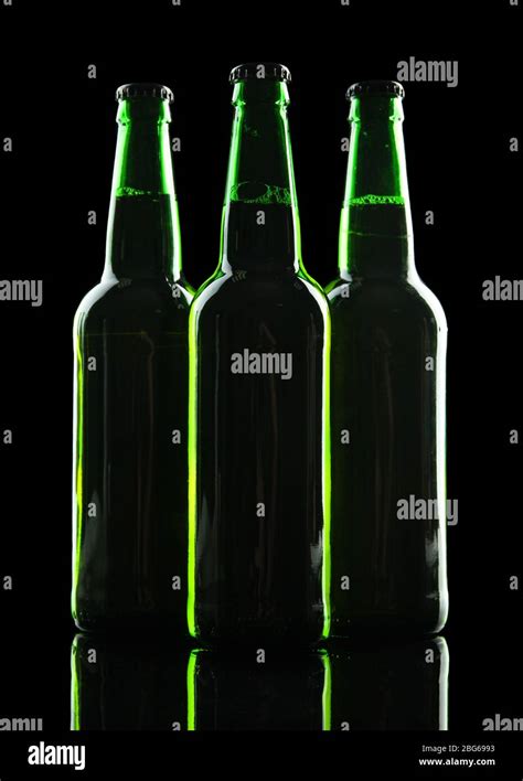 Bottles of beer on black background Stock Photo - Alamy