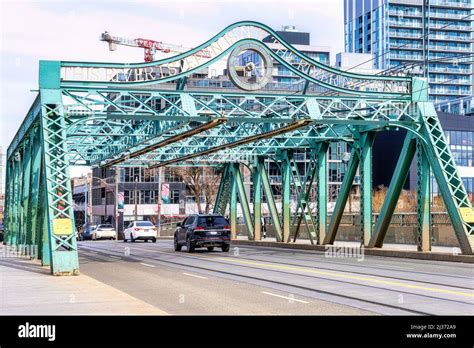 Metallic Pratt truss bridge known as the Queen St. Viaduct (1911). The old structure is an ...