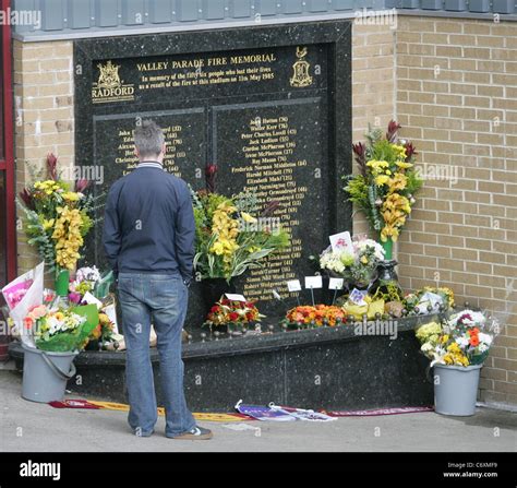 People visit the memorial for the victims of the Bradford City stadium fire on the 25th ...