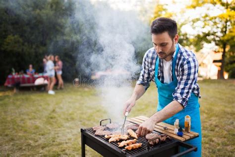 Handsome Young Male Preparing Barbecue in Nature Stock Image - Image of ...