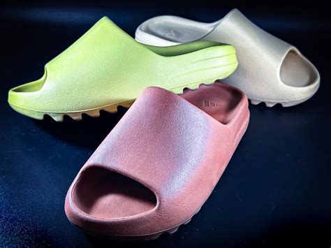 Yeezy Slides on Blue Surface · Free Stock Photo