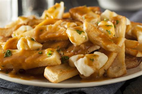 Poutine topped with cheese curds - Delicious Food & Wine