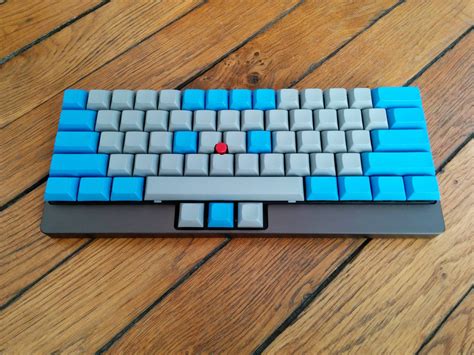 a blue and gray keyboard sitting on top of a wooden floor