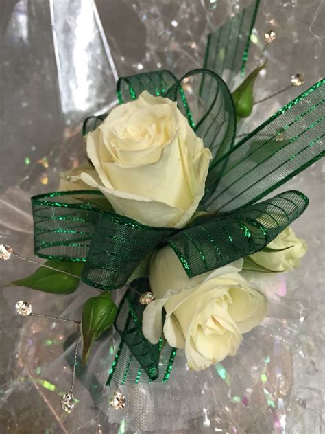 Wristlet corsage with white spray roses, emerald green ribbon, clear ...