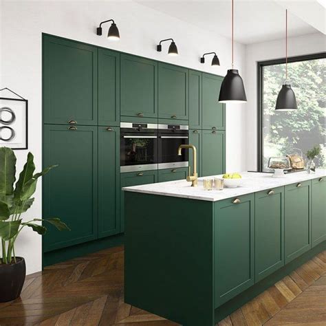 dark green modern kitchen with black light fixtures and herringbone wood flooring # ...