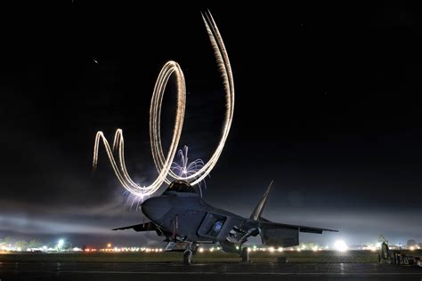 An Air Force F-22 assigned to the F-22 Raptor Demo Team sits on the flightline during a twilight ...