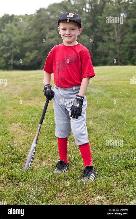 Little boy dressed ina baseball uniform with a baseball glove ready to ...