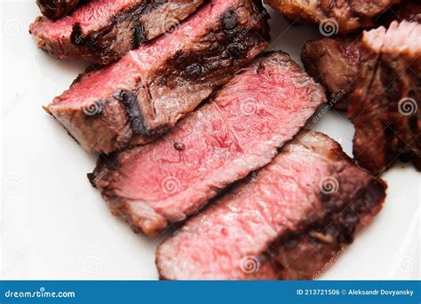 Sliced Medium Rare Steak with Blood on a Plate Close-up. Macro Stock ...