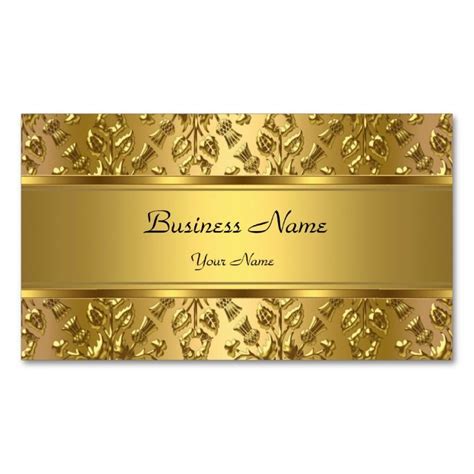 a business card with gold floral design on the front and bottom, along with a name tag