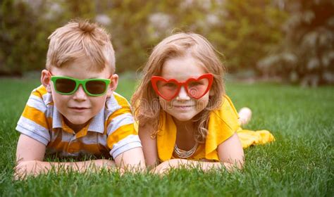 Happy Children Boy and Girl Playing on Green Grass in Park. Kids in ...