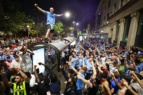 In pictures: Elated Manchester City fans celebrate into night after ...