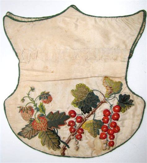 Shield-shaped ivory silk reticule, circa 1830. The purse features apple green piping, applied ...