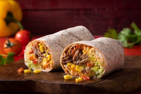 Mexican burrito with shredded beef, guacamole, seasoned corn, roasted ...