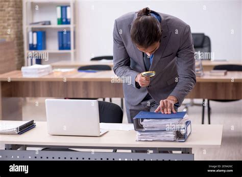 Young employee in industrial espionage concept Stock Photo - Alamy