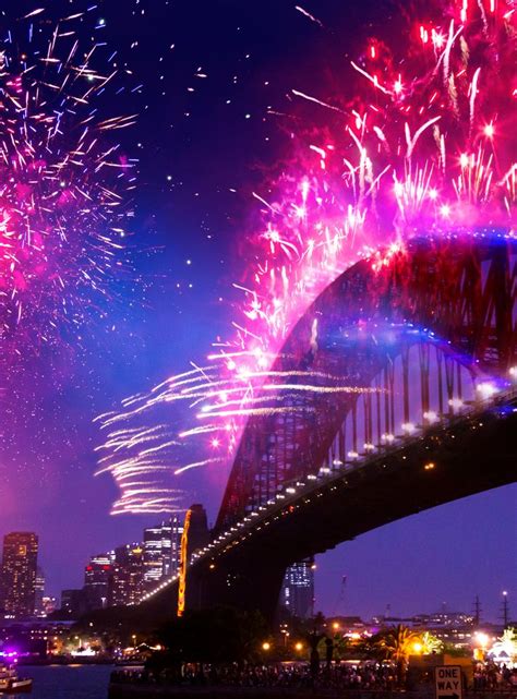 fireworks are lit up over the sydney harbour bridge