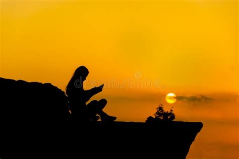 Silhouette of a Girl Reading at Sunset Stock Photo - Image of people ...