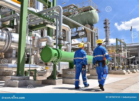 Chemical Industry Plant - Workers in Work Clothes in a Refinery with Pipes and Machinery Stock ...