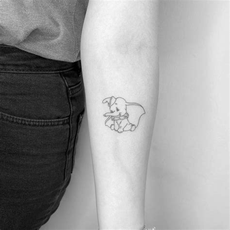 FIne line dumbo tattoo on the inner forearm.