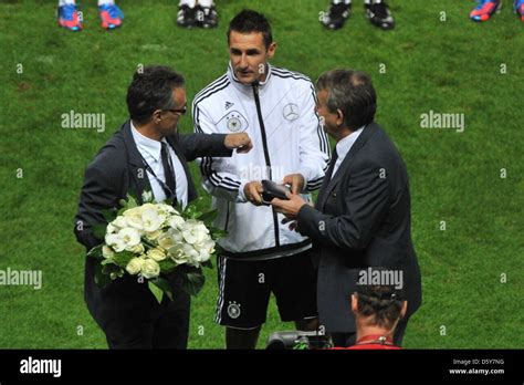 Germany's Miroslav Klose (C) receives Fair-Play Award from Wolfgang Niersbach (R), president of ...