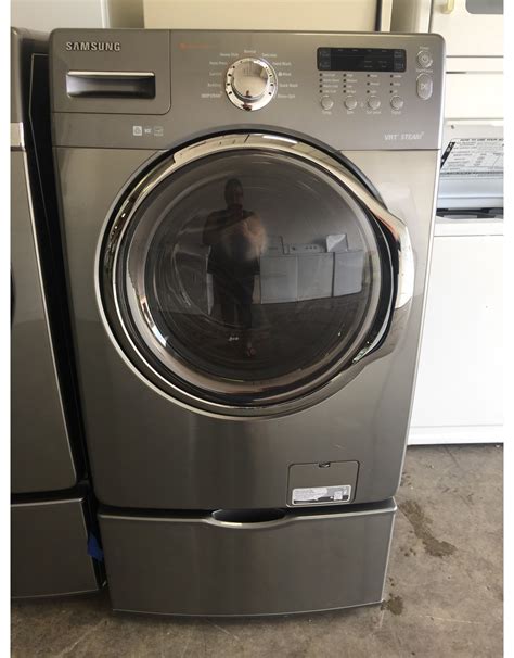 SAMSUNG SAMSUNG FRONT LOAD STEAM WASHING MACHINE W/PEDESTAL IN STEEL GRAY - Discount City Appliance