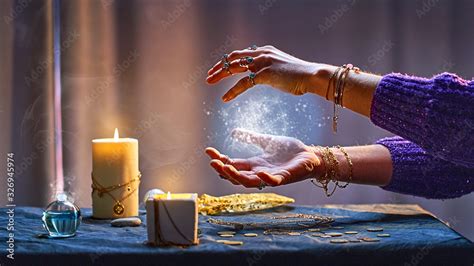 Magical luminous swirling glowing ball in the palm of a witch wizard woman during a witchcraft ...