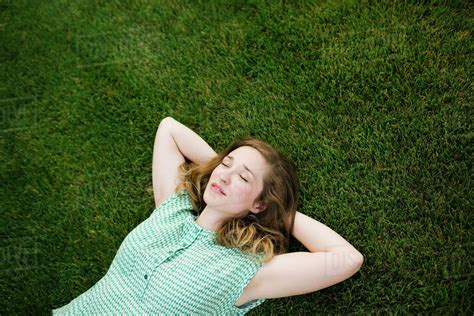 Woman lying on grass and sleeping - Stock Photo - Dissolve