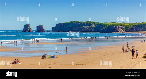 HENDAYE, FRANCE - JUNE 8: Tourists and surfers enjoy the beach of the charming seaside resort of ...