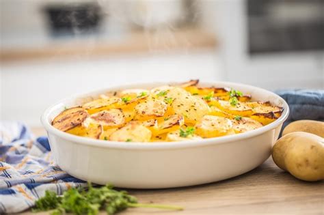 Premium Photo | Roasted potatoes with spices and herbs on kitchen table