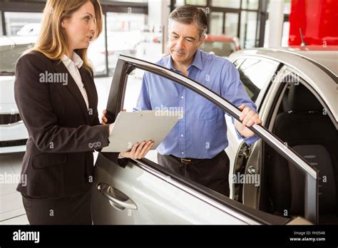 Focused businessman undersign a car contract Stock Photo - Alamy