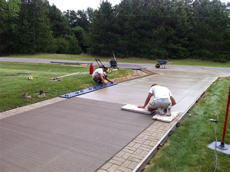 In progress photo. Brush finished concrete driveway with stamped boarders and sidewalk. Stamped ...