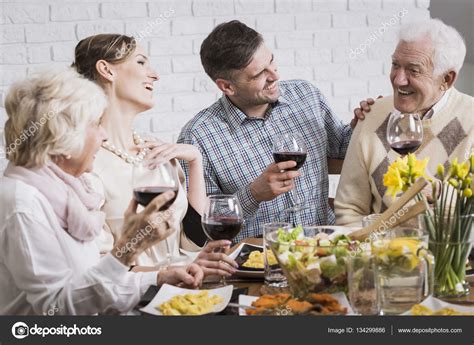 Laughing family during dinner — Stock Photo © photographee.eu #134299886