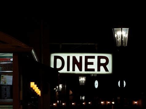 A diner at night with the street lit up in the background - very ...