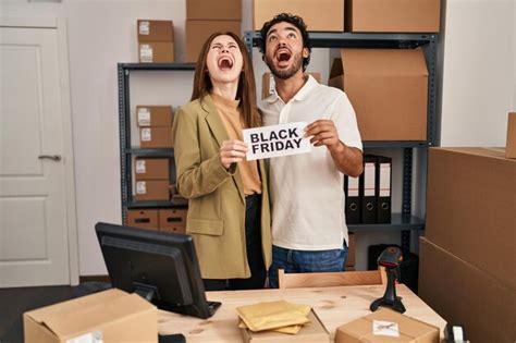 Premium Photo | Young two people holding black friday banner at small ...