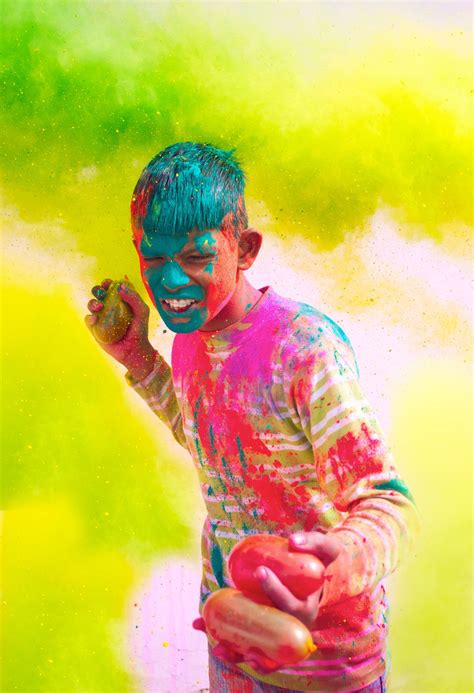 Holi celebrations- Young Indian boy playing with water balloons on Holi festival : World ...