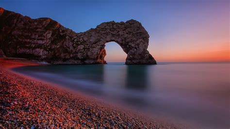 Durdle Door natural rock arch at sunset (Jurassic Coast, England) - backiee