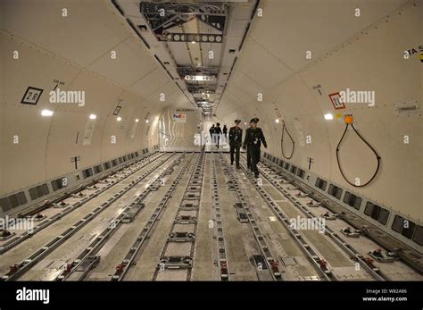 Chinese paramilitary policemen check the cabinet of the FedEx Boeing 777 jet plane, carrying the ...