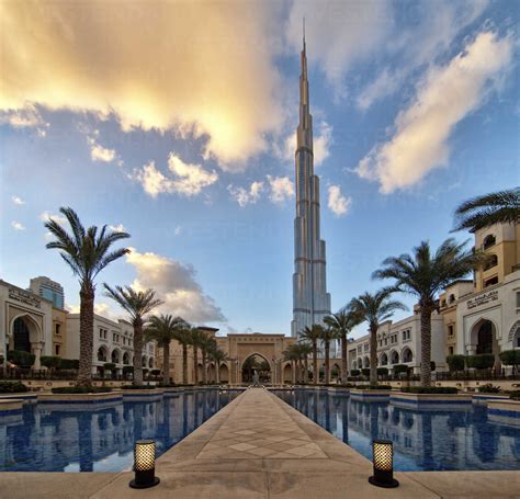 Hotel swimming pool with Burj Khalifa skyscraper in the distance, Dubai, United Arab Emirates ...