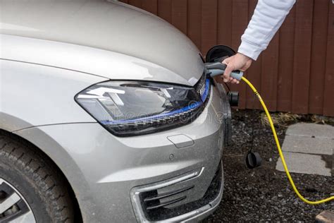 Charging an Electric Car with the Power Cable Supply Plugged in ...