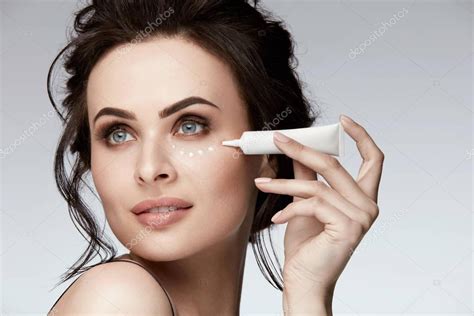 Eye Skin Care. Woman Applying Eye Cream On Skin — Stock Photo © puhhha #175254840