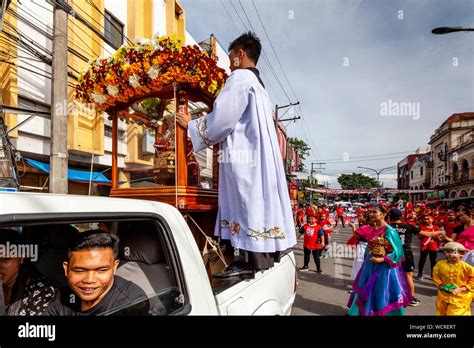 A Santo Nino Statue Is Transported Through The Streets At The Head Of A ...