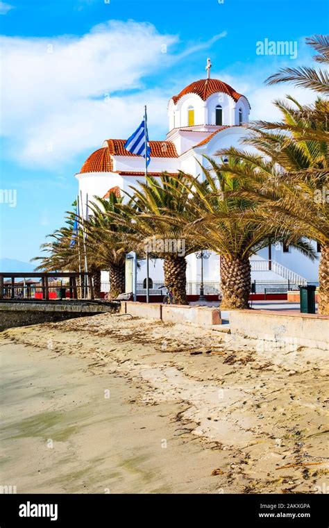 Greek orthodox Church in Paralia Katerini, wooden pier, palm trees and ...