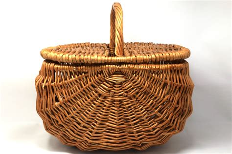 a wicker basket with handle is shown on a white background