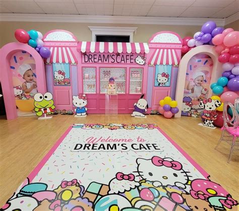 a hello kitty themed birthday party with balloons and decorations for the entrance to dream cafe