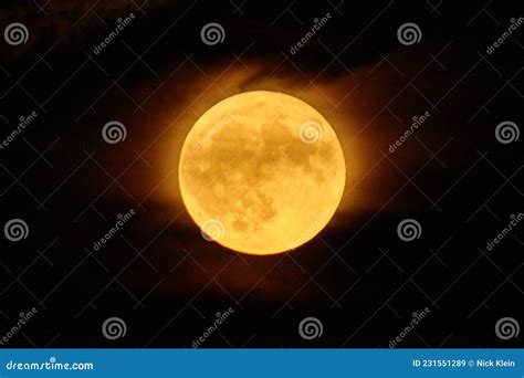 Full Moon that is a Harvest Moon Glowing Orange with a Misty Cloud ...