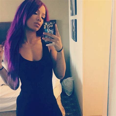 a woman with purple hair is taking a selfie in her hotel room while holding a cell phone