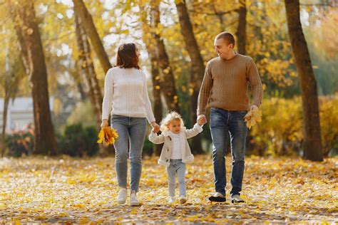 Happy family walking on alley in autumn park · Free Stock Photo